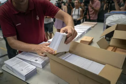 An election worker shows ballots to the media before being distributed at polling stations, at a warehouse in Barcelona, Spain, July 18, 2023. Claims of vote rigging and election fraud are spreading in Spain ahead of that nation's pivotal election on Sunday. The allegations are strikingly similar to claims spread by ex-President Donald Trump and others in the United States ahead of the 2020 election. (AP Photo/Emilio Morenatti, File)