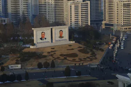 Portraits of late North Korean leaders Kim Il Sung and Kim Jong Il sit in downtown Pyongyang, North Korea on Dec. 19, 2018. North Korea is continuing to steal hundreds of millions of dollars from financial institutions and cryptocurrency firms and exchanges, illicit money that is an important source of funding for its nuclear and missile programs, U.N. experts said in a report quoting cyber specialists. (AP Photo/Dita Alangkara, File)