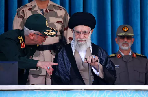 In this picture released by the official website of the office of the Iranian supreme leader, Supreme Leader Ayatollah Ali Khamenei, center, listens to chief of the General Staff of the Armed Forces Gen. Mohammad Hossein Bagheri at a graduation ceremony for a group of armed forces cadets at the police academy in Tehran, Iran, Monday, Oct. 3, 2022. Khamenei responded publicly on Monday to the biggest protests in Iran in years, breaking weeks of silence to condemn what he called “rioting” and 