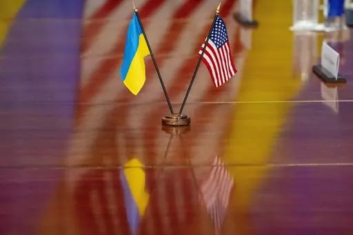The Ukrainian and United States flags are placed on the table during a meeting with Secretary of Defense Lloyd Austin and Ukrainian Prime Minister Denys Shmyhal at the Pentagon, Wednesday, April 12, 2023, in Washington. (AP Photo/Alex Brandon)