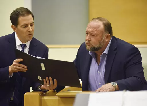 Plaintiff's attorney Chris Mattei, left, questions Conspiracy theorist Alex Jonesduring testimony at the Alex Jones Sandy Hook defamation damages trial at Connecticut Superior Court in Waterbury, Conn. Thursday, Sept. 22, 2022. Jones was found liable last year by default for damages to plaintiffs without a trial, as punishment for what the judge called his repeated failures to turn over documents to their lawyers. The six-member jury is now deciding how much Jones and Free Speech Systems, Infowa