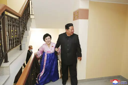 In this photo provided by the North Korean government, Kim Jong Un visits the new house of Korean Central Broadcasting announcer Ri Chun Hi, second right, after attending an inauguration ceremony of Pothong riverside terraced residential district in Pyongyang, North Korea Wednesday, April 13, 2022. Independent journalists were not given access to cover the event depicted in this image distributed by the North Korean government. The content of this image is as provided and cannot be independently