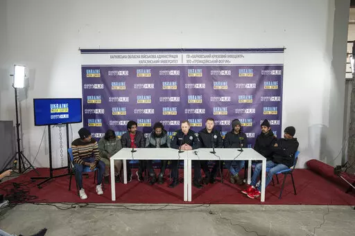 Sri-lankan former captives Nilojan Vasanthakumar, 20, Uthayakamar Mary Edid Prema, 50, Sharujan Gianeswaran, 25, Thinees Jokenthhiran, 34, Dilukshan Robertclive, 25, Dilujan Paththinajakan, 20, Ainkaranathan Ganesamoorthi, 38 and Head of investigation police department attend a press conference in Kharkiv, Ukraine, Saturday, Sept. 24, 2022. Seven Sri Lankans held captive by Russian forces in an agricultural factory in eastern Ukraine say they were beaten and tortured for months before escaping o