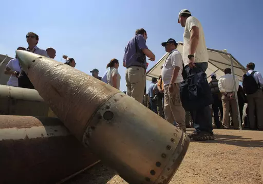 Activists and international delegations stand next to cluster bomb units, during a visit to a Lebanese military base at the opening of the Second Meeting of States Parties to the Convention on Cluster Munitions, in the southern town of Nabatiyeh, Lebanon, Sept. 12, 2011. The Biden administration has decided to provide cluster munitions to Ukraine and is expected to announce on Friday, July 6, 2023, that the Pentagon will send thousands as part of the latest military aid package for the war effor