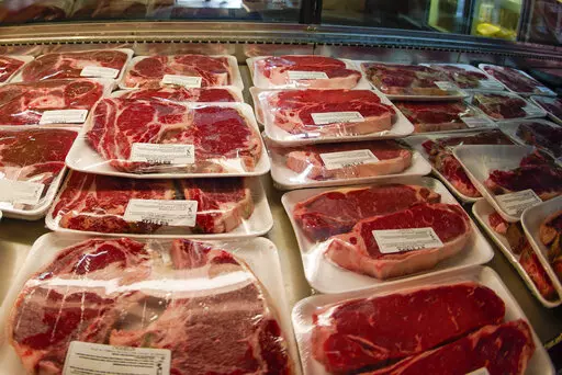 In this photo made on June 16, 2022, rows of fresh cut beef is in the coolers of the retail section at the Wight's Meat Packing facility in Fombell, Pa. Federal agriculture officials on Monday, March 6, 2023 released new requirements that would allow labels on meat, poultry or eggs to claim that phrase -- or “Product of USA” -- only if they come from animals “born, raised, slaughtered and processed in the United States.” (AP Photo/Keith Srakocic, File )