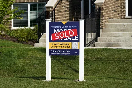 An advertising sign for building land stands in front of a new home construction site in Northbrook, Ill., Wednesday, Sept. 21, 2022. From rising home prices to soaring interest rates, it’s a daunting time to be a home buyer. To achieve homeownership, some single buyers are trying a different approach: co-buying with friends or family members. But co-buying isn’t a short-term hack – it’s a lifestyle shift. Before you team up, experts recommend having vulnerable conversations about your f