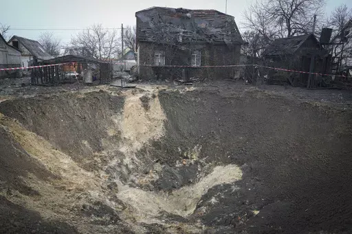 A general view of the crater at a site of recent Russian missile attack in Kyiv, Ukraine, Monday, Dec. 11, 2023. (AP Photo/Efrem Lukatsky)