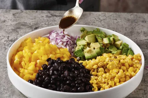 This 2021 image shows a recipe for bean salad, known as Cowboy Caviar. It's a protein-packed addition to any summer cookout. (Cheyenne M. Cohen via AP)
