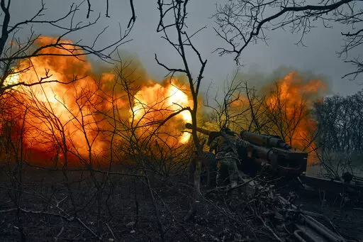 Ukrainian soldiers fire an artillery at Russian positions near Bakhmut, Donetsk region, Ukraine, Sunday, Nov. 20, 2022. (AP Photo/LIBKOS)