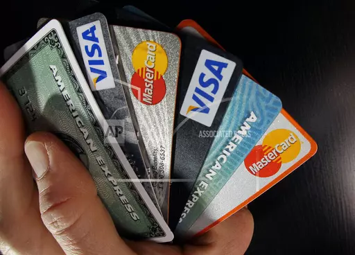 Consumer credit cards are posed in North Andover, Mass., March 5, 2012. The Consumer Financial Protection Bureau is considering a new rule that would slash credit card late fees by 75%, from current highs of up to $41 to as low as $8. (AP Photo/Elise Amendola, File)