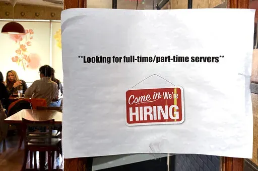 A hiring sign is displayed at a restaurant in Morton Grove, Ill., Thursday, April 28, 2022.  Labor Department releases weekly report on unemployment benefits on Wednesday, Nov. 23.  (AP Photo/Nam Y. Huh, File)