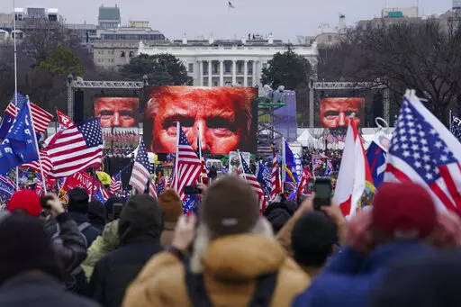 In this Jan. 6, 2021 file photo, Trump supporters participate in a rally in Washington. On Friday, Oct. 21, 2022, The Associated Press reported on stories circulating online incorrectly claiming that former President Donald Trump signed an order to deploy 20,000 National Guard troops before his supporters stormed the U.S. Capitol on Jan. 6, 2021, but was stopped by the House sergeant at arms, at the behest of Speaker Nancy Pelosi.  (AP Photo/John Minchillo, FIle)