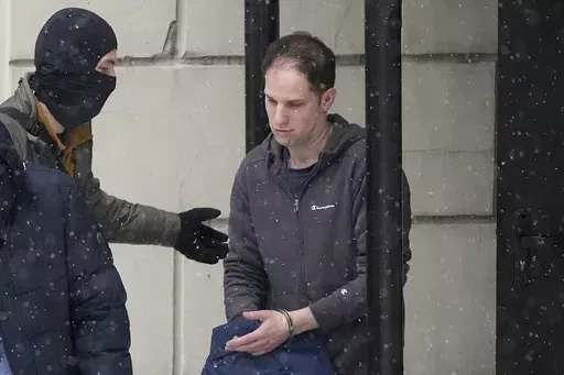 Wall Street Journal reporter Evan Gershkovich is escorted from court after a hearing in Moscow, Russia, Friday, Jan. 26, 2024. Arrests of Americans in Russia have become increasingly common as relations between Moscow and Washington sink to Cold War lows. Some have been exchanged for Russians held in the U.S., while for others, the prospects of being released in a swap are less clear. (AP Photo/Alexander Zemlianichenko, File)