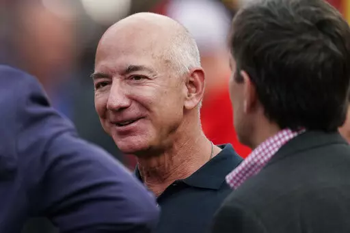 Amazon founder Jeff Bezos is seen on the sidelines before the start of an NFL football game, Sept. 15, 2022, in Kansas City, Mo. Bezos said in an interview with CNN that he will give away the majority of his wealth during his lifetime. The billionaire didn’t specify how - or to whom - he will give away the money, but said he and his girlfriend, Lauren Sanchez, were building the “capacity” to do it. Bezos has been criticized in the past for not pledging to donate the majority of his wealth 