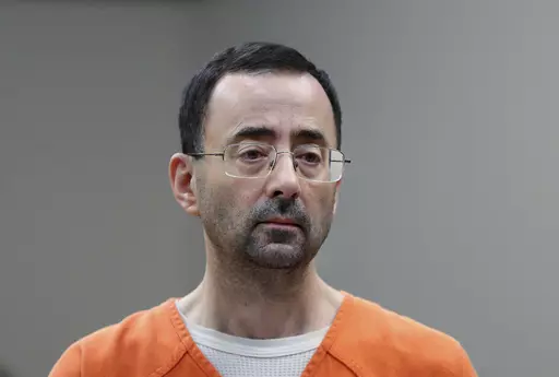 Dr. Larry Nassar, 54, appears in court for a plea hearing in Lansing, Mich., on Nov. 22, 2017. Recent assaults on two notorious, high-profile federal prisoners have renewed concerns about whether the federal Bureau of Prisons is capable of keeping people in its custody safe. Nassar was knifed repeatedly in his cell at a federal penitentiary in Florida in July. (AP Photo/Paul Sancya, File)