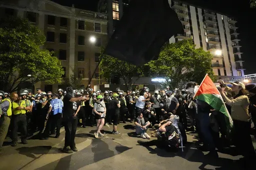 Protesters sit in the street during a demonstration near the Democratic National Convention Thursday, Aug. 22, 2024, in Chicago. (AP Photo/Alex Brandon)