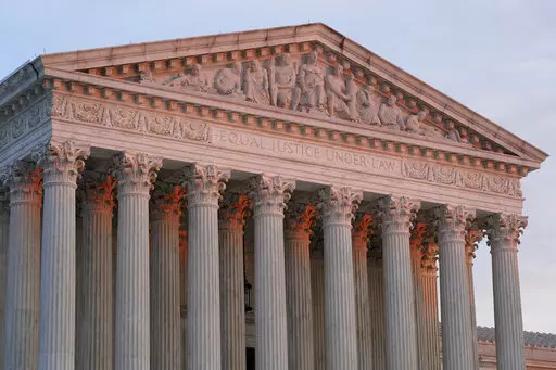 The setting sun illuminates the Supreme Court building on Capitol Hill in Washington, Jan. 10, 2023. The Supreme Court on Friday, Jan. 13, agreed to consider what employers must do to accommodate religious employees, among eight new cases it added. (AP Photo/Patrick Semansky, File)