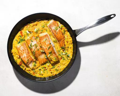This image released by Milk Street shows a recipe for Salmon in Coconut-Curry Sauce. (Milk Street via AP)