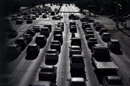 Cars wait at a red light during rush hour, April 22, 2021, in Las Vegas. Motor vehicles with higher, more vertical front ends are the most dangerous to pedestrians, according to a highway safety organization. (AP Photo/John Locher, File)