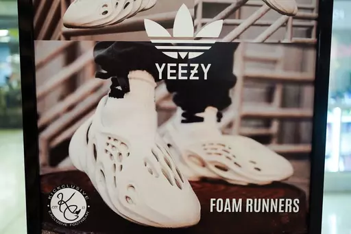 A sign advertises Yeezy shoes made by Adidas at Kickclusive, a sneaker resale store, in Paramus, N.J., on Oct. 25, 2022. Adidas said Friday, May 19, 2023, that it will begin selling its more than $1 billion worth of leftover Yeezy sneakers later this month, with the proceeds to be donated to various anti-racism groups. (AP Photo/Seth Wenig, File)