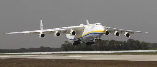 The Ukrainian Antonov-225 Mriya (Dream), the world's heaviest and largest aircraft, makes a test landing at the new runway at the airport in Donetsk, Ukraine on July 26, 2011. Ukraine's defense industry conglomerate says the world's largest plane that was in regular operation was heavily damaged in fighting with Russian troops at the airport outside Kyiv where it was parked. (AP Photo/Sergey Vaganov, File)