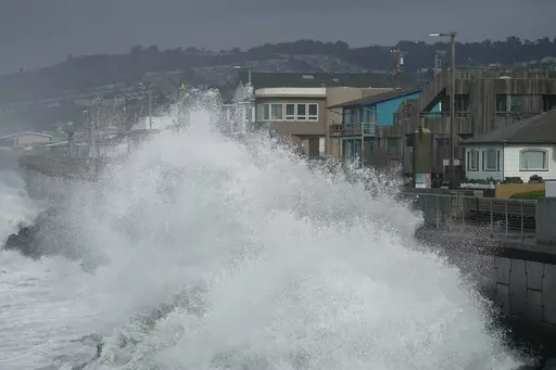 Large waves crash into a seawall in Pacifica, Calif., on Jan. 6, 2023. Giant waves, measuring as high as 13 feet, are becoming more common off California's Pacific coast as the planet warms, according to new research that used a unique approach to gather historical data over the past 90 years to track the increasing height of the surf. (AP Photo/Jeff Chiu, File)