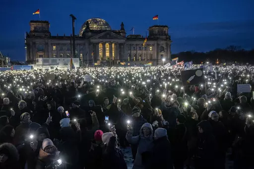 People hold up their cell phones as they protest the far-right Alternative for Germany, or AfD party, and right-wing extremism in front of the parliament building in Berlin, Germany, Jan. 21, 2024. Millions of Germans have joined rallies all over the country for weeks in a row, attending events with slogans such as "Never Again is Now." The protesters have been alarmed by the AfD's policies and its growing popularity. (AP Photo/Ebrahim Noroozi, File)
