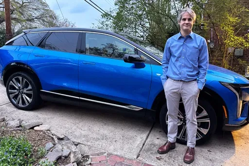 Rob Blackwell stands next to an EV he started leasing right before U.S. President Donald Trump announced expansive new import tariffs, in Richmond, Va., on April 3, 2025. (Maia Curtis via AP)