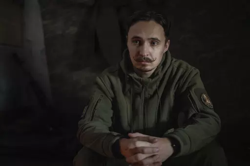 The serviceman of 47th brigade known by call-sign "Azimuth", 33, pauses, during an interview with The Associated Press, in Donetsk region, Ukraine, Thursday, Feb. 29, 2024. The loss of the city of Avdiivka last month marked the end of a long, exhausting defense for the Ukrainian military. One brigade had defended the same block of buildings for months without a break. (AP Photo/Alex Babenko)
