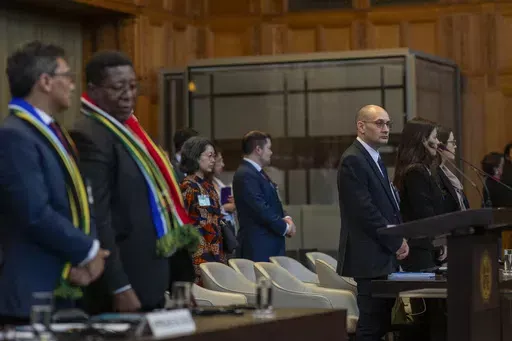Front row from left, South Africa's agents Cornelius Scholtz, Vusimuzi Madonsela and Israel's agents Gilad Naom, Tamar Kaplan Tourgeman and co-agent Avigail Frisch Ben Avraham wait for the start of hearings at the International Court of Justice, in The Hague, Netherlands, Thursday, May 16, 2024. The U.N.'s top court opened two days of hearings in a case brought by South Africa to see whether Israel needs to take additional measures to alleviate the suffering in war-ravaged Gaza. (AP Photo/Peter 