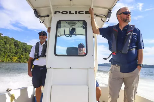 ADVANCE FOR PUBLICATION ON SATURDAY, SEPT. 17, AND THEREAFTER - Tennessee Valley Authority's Roy Rogers, center, drives the boat as Jimmy Nelson, left, and Paul Avery stand by, on Sept. 9, 2022, in Chattanooga, Tenn. Tennessee Valley Authority's cultural team and police gathered at the Taylor Boat Ramp at the Chickamauga Day-Use Area, to bring awareness to the area's rich history and what to do if artifacts are found. Looting cultural resources is an issue that TVA would like to call attention t