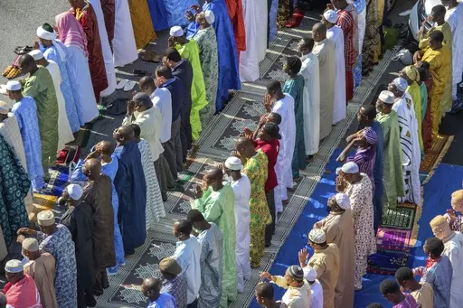 FILE — Worshipers in New York's East Harlem neighborhood take part in the traditional annual prayer commemorating the end of Ramadan, in front of the Masjid Aqsa-Salam mosque, on July 17, 2015. New York Mayor Eric Adams announced new guidelines Tuesday, Aug. 29, 2023, allowing mosques to broadcast the Muslim call to prayer on Fridays and at sundown during the holy month of Ramadan. (AP Photo/Bryan R. Smith, File)
