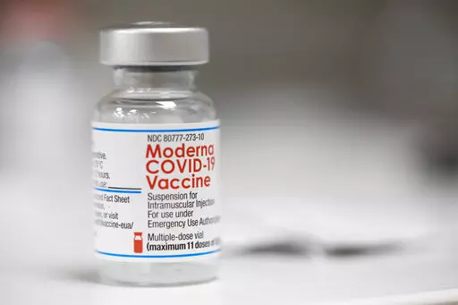 A vial of the Moderna COVID-19 vaccine is displayed on a counter at a pharmacy in Portland, Ore. on Dec. 27, 2021. A government advisory panel met Tuesday, June 14, 2022,  to decide whether to recommend a second brand of COVID-19 vaccine for school-age children and teens. The Food and Drug Administration's outside experts will vote on whether Moderna's vaccine is safe and effective enough to give kids ages 6 to 17.  If the panel endorses the shot and the FDA agrees, it would become the second op