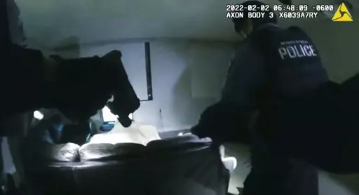 In this image taken from Minneapolis Police Department body camera video and released by the city of Minneapolis, Minneapolis police enter an apartment on Wednesday, Feb. 2, 2022, moments before shooting 22-year-old Amir Locke. Minneapolis Mayor Jacob Frey has imposed a moratorium on no-knock warrants after Locke was killed as a SWAT team carried out a search warrant in a downtown apartment. (Minneapolis Police Department via AP)