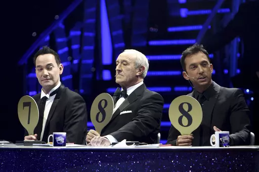 From left, judges Craig Revel Horwood, Len Goodman and Bruno Tonioli gesture, during the final dress rehearsal for the opening of the 'Strictly Come Dancing Live Tour' at the NIA, Birmingham, England, Jan. 20, 2012. Len Goodman, an urbane long-serving judge on “Dancing with the Stars” and “Strictly Come Dancing,” has died, his agent said Monday, April 24, 2023. He was 78. A former dancer, Goodman was a judge on “Strictly Come Dancing” for 12 years from its launch on the BBC in 2004. 