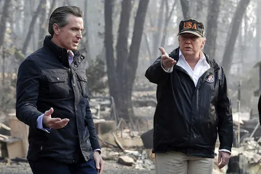 President Donald Trump talks with then California Gov.-elect Gavin Newsom, left, during a visit to a neighborhood impacted by the wildfires in Paradise, Calif., Nov. 17, 2018. (AP Photo/Evan Vucci, File)