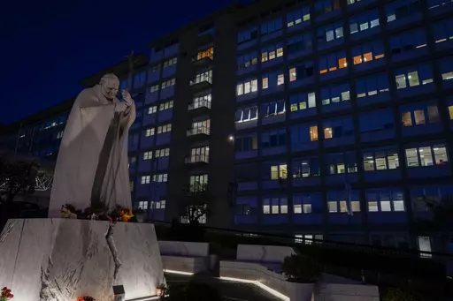 A statue of late Pope St. John Paul II is backdropped by the Agostino Gemelli hospital in Rome, Wednesday, March 29, 2023, after The Vatican said Pope Francis has been taken there in the afternoon for some scheduled tests. The Vatican provided no details, including how long the 86-year-old pope would remain at Gemelli University Hospital, where he underwent surgery in 2021. But his audiences through Friday were canceled, raising questions about Francis' participation during the Vatican's Holy We