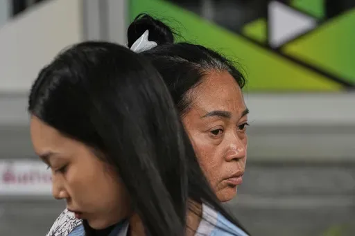 Naruemol Thonglek, right, with her daughter, waits for news of her partner, who is missing after the collapse of an under-construction high-rise building after an earthquake in Bangkok, Thailand, Monday, March, 31, 2025. (AP Photo/Manish Swarup)