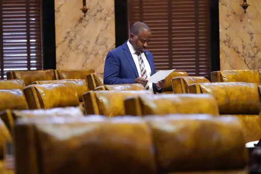 Rep. Ronnie Crudup Jr., D-Jackson, studies an updated grid of the total state support for agencies for fiscal year 2023, in the House chamber at the Mississippi Capitol in Jackson, Miss., on April 4, 2022. Crudup Jr., who has represented south Jackson since 2019, was preparing for the Legislature's upcoming return to session on Jan. 3 when he lost water on Dec. 24, 2022, after frigid weather upended infrastructure across the Deep South. (AP Photo/Rogelio V. Solis, File)