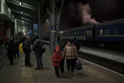 People trying to flee Ukraine wait for trains inside Lviv railway station in Lviv, western Ukraine, Friday, March 4, 2022. (AP Photo/Felipe Dana)