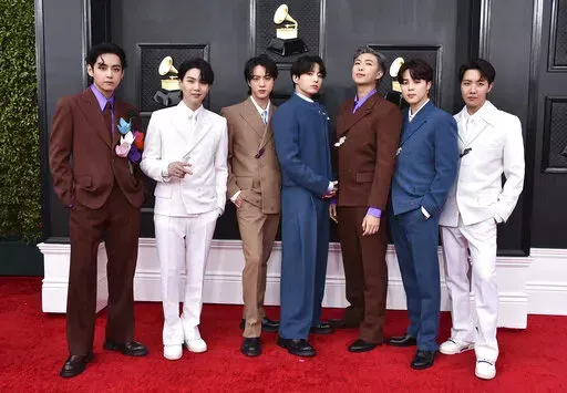 BTS arrives at the 64th Annual Grammy Awards on April 3, 2022, in Las Vegas. The group says they are taking time to focus on solo projects. The seven-member group with hits like “Butter” and “Dynamite” talked about their future in a video posted June 14, celebrating the nine year anniversary of their debut release.  (Photo by Jordan Strauss/Invision/AP, File)