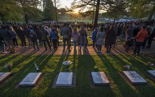 Worshippers listen to the liturgy as the sun rises over the Salem Congregation's God's Acre graveyard during the 251st Easter Sunrise Service of the Moravian Church, Sunday, April 9, 2023. On Easter morning, many Christians wake before dawn. They will celebrate their belief in the resurrection of Jesus, the son of God, as the sun rises. (Walt Unks/The Winston-Salem Journal via AP, File)