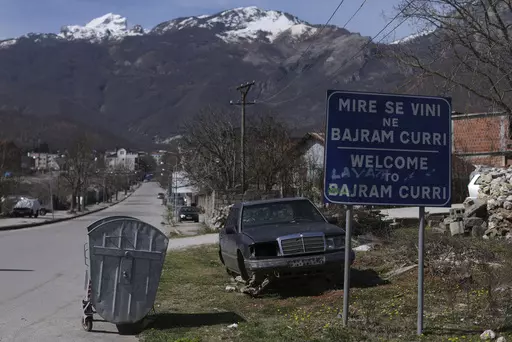 A welcome sign is seen at the entrance of Bajram Curri town, 240 kilometers (150 miles) northern of Tirana, Albania, Tuesday, March 14, 2023. Thousands of young Albanians have crossed the English Channel in recent years to seek a new life in the U.K. Their dangerous journey in small boats or inflatable dinghies reflects Albania's anemic economy and a younger generation’s longing for fresh opportunities. (AP Photo/Franc Zhurda)