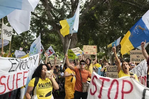 People march during a mass demonstration against over tourism, which affects the local population with inaccessible housing, among other things, in Santa Cruz de Tenerife, Spain, April 20, 2024. (AP Photo/Miguel Velasco Almendral, file)
