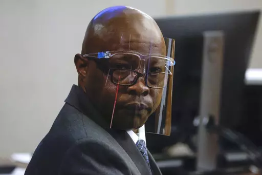 Accused serial killer Billy Chemirmir looks back ahead of his third trial at Frank Crowley Courts Building, Oct. 3, 2022, in Dallas. Chemirmir, who was accused of killing nearly two dozen older women and convicted in 2022 in the slayings of two, was killed Tuesday morning, Sept. 19, 2023, by his cellmate at a Texas prison, an official said. (Shafkat Anowar/The Dallas Morning News via AP, File)