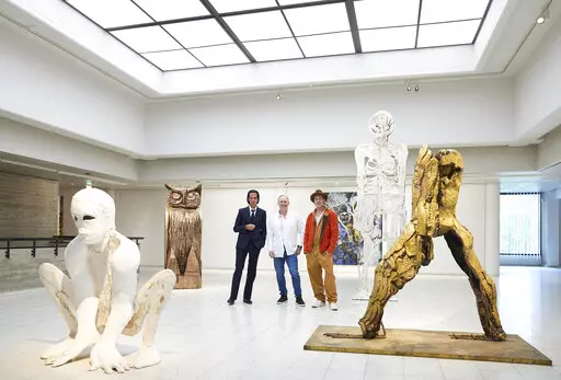 In this photo provided by Sara Hilden Art Museum, British artist Thomas Houseago, centre, poses with US actor Brad Pitt, centre right and Australian musician Nick Cave, prior to the opening of their joint exhibition, in Tampere, Finland, Saturday, Sept. 17, 2022. (Jussi Koivunen/Sara Hilden Art Museum, Lehtikuva via AP)