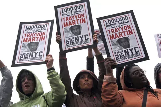 Demonstrators hold signs in support of Trayvon Martin in Union Square Wednesday, March 21, 2012 in New York.  Ten years ago when Trayvon Martin was fatally shot, Florida was one of the few states with “stand your ground” laws that eased use of deadly force in the face of danger. Now, upwards of 30 states have some form of the law and recent research indicates they're associated with more deaths _ as many as 700 additional gun killings each year, according to a study published this week in th