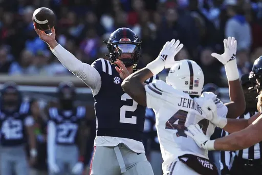 Mississippi quarterback Jaxson Dart (2) passes while being pressured by Mississippi State linebacker Branden Jennings (44) during the first half of an NCAA college football game, Friday, Nov. 29, 2024, in Oxford, Miss. (AP Photo/Rogelio V. Solis)