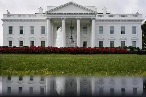 The White House is seen reflected in a puddle, Saturday, Sept. 3, 2022, in Washington. In a politically polarized nation, Americans seem to agree on one issue underlying the 2024 elections — a worry over the state of democracy and how the outcome of the presidential contest will affect its future. A poll from The Associated Press-NORC Center for Public Affairs Research found that 62% of adults say democracy in the U.S. could be at risk depending on who wins. That view is held by 72% of Democra