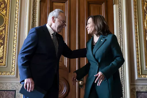 Senate Majority Leader Sen. Chuck Schumer, D-N.Y., talks with Vice President Kamala Harris after presenting Harris with a golden gavel after she cast the 32nd tie-breaking vote in the Senate, the most ever cast by a vice president, Tuesday, Dec. 5, 2023, on Capitol Hill in Washington. (AP Photo/Stephanie Scarbrough)